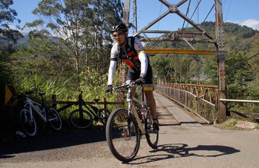 Cyclist riding from a bridge