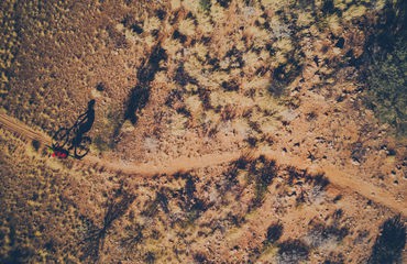 Aerial view of cyclist on desert track
